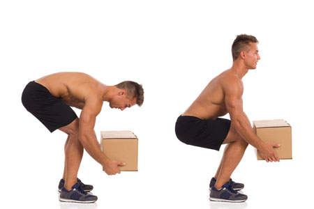 Man demonstrating how to lift a box as part of a workplace physical therapy program
